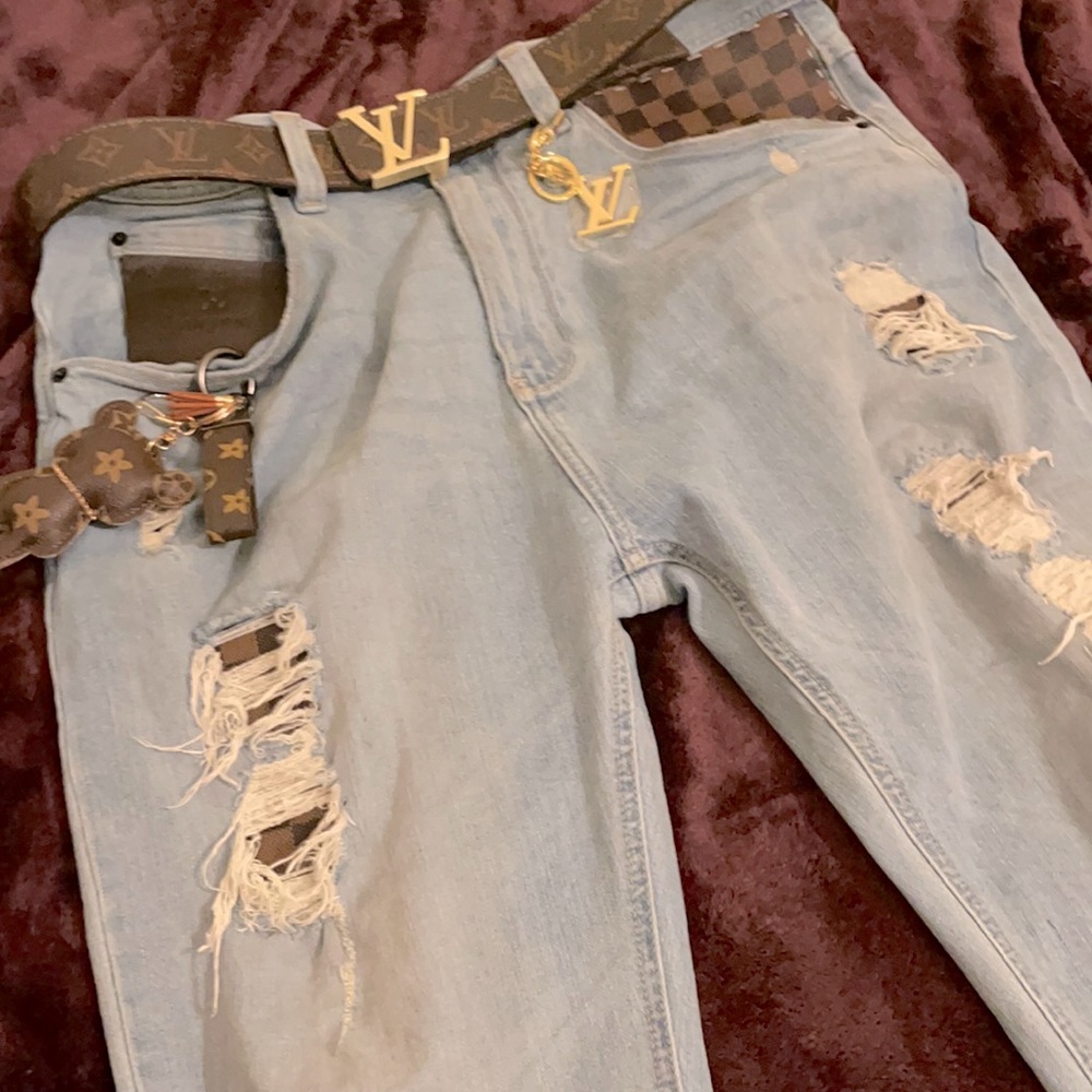 it’s custom made ONE OF A KIND jeans cut fashion bags and sewed them into jeans